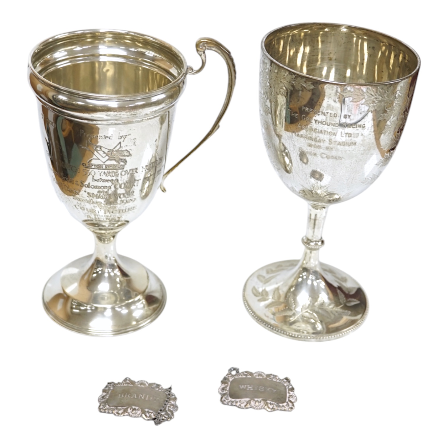 A Victorian engraved silver goblet, by Robert Harper, London 1871, with later engraved Greyhound Racing Association Ltd presentation inscription, 23.1cm, one other damaged silver trophy cup and two modern silver wine lab